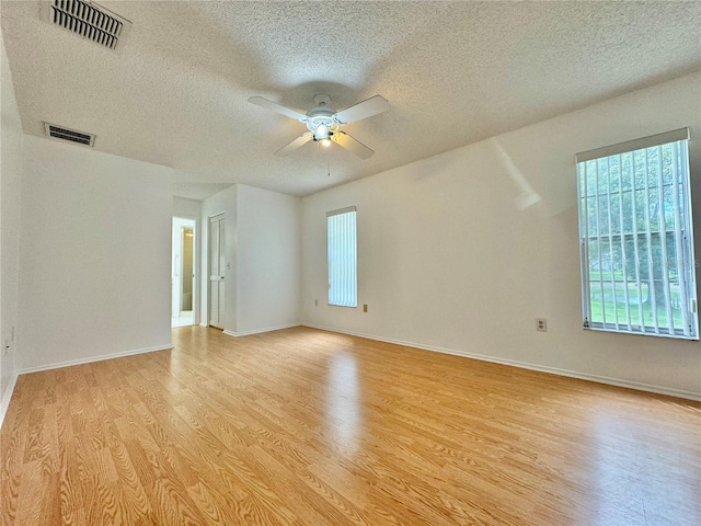 unfurnished room featuring a textured ceiling, ceiling fan, and light hardwood / wood-style floors