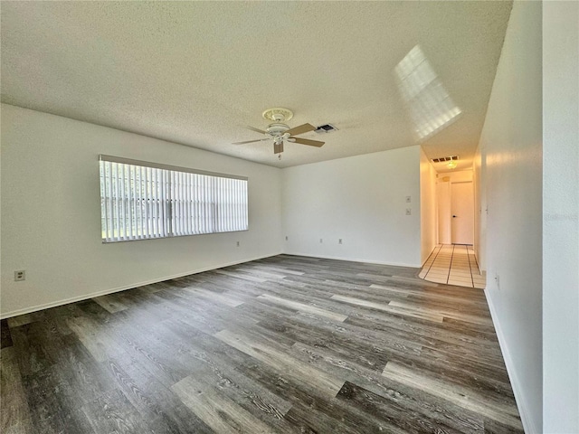 unfurnished room with a textured ceiling, hardwood / wood-style floors, and ceiling fan