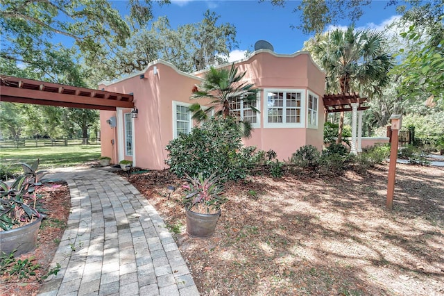 view of side of home with a pergola