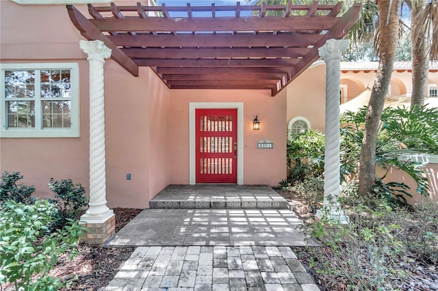 property entrance featuring a pergola