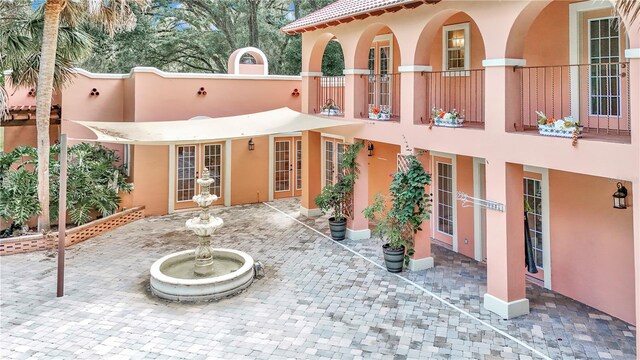 back of property with a patio and a balcony