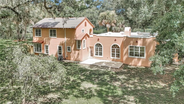 rear view of house featuring a patio and central air condition unit