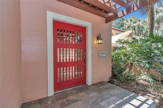 entrance to property with a pergola and a patio area