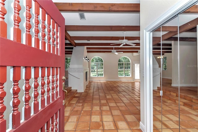 unfurnished bedroom featuring beamed ceiling and light tile patterned floors