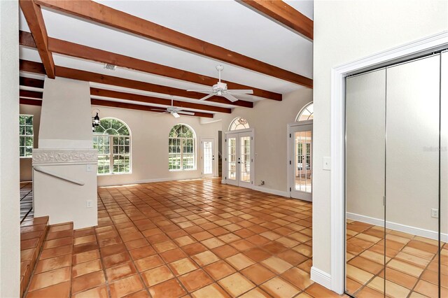 unfurnished living room with beam ceiling, french doors, light tile patterned floors, and ceiling fan