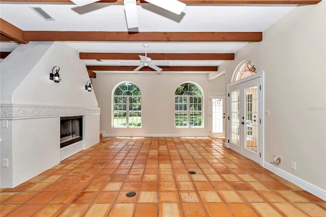 unfurnished living room featuring beamed ceiling, light tile patterned flooring, ceiling fan, and french doors