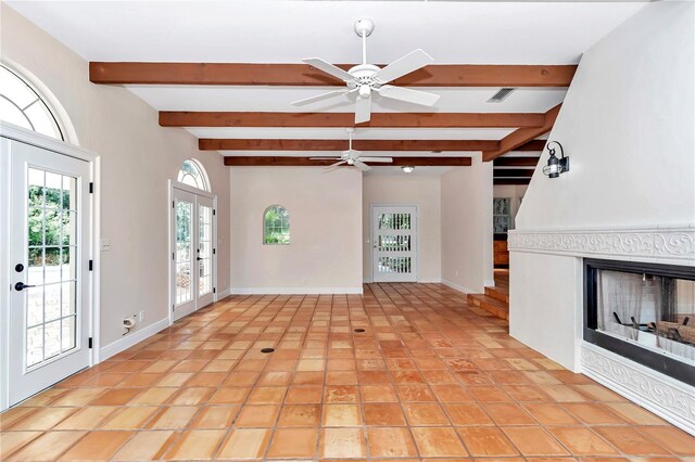 unfurnished living room with a healthy amount of sunlight, light tile patterned floors, and ceiling fan