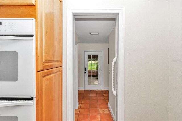 hallway with tile patterned flooring