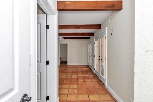 corridor featuring beam ceiling and light tile patterned floors