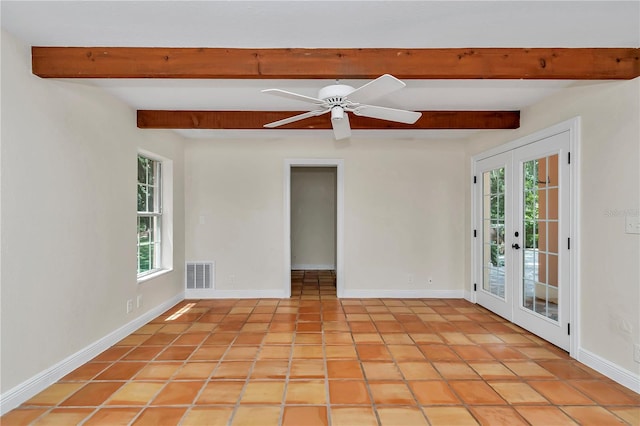 tiled spare room featuring a wealth of natural light, beam ceiling, and ceiling fan