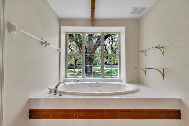 bathroom with a relaxing tiled tub