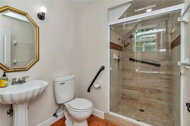 bathroom with toilet and a shower with door