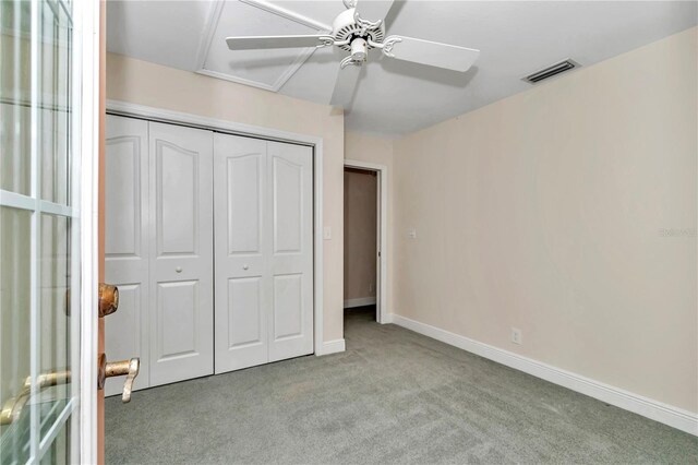 unfurnished bedroom with carpet, ceiling fan, and a closet