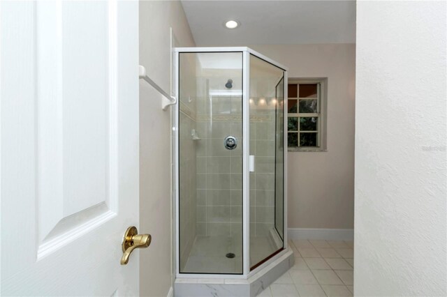 bathroom with tile patterned floors and an enclosed shower