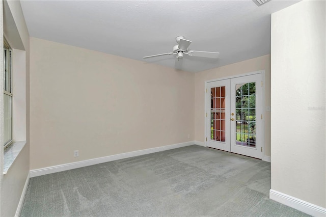 carpeted spare room with french doors and ceiling fan