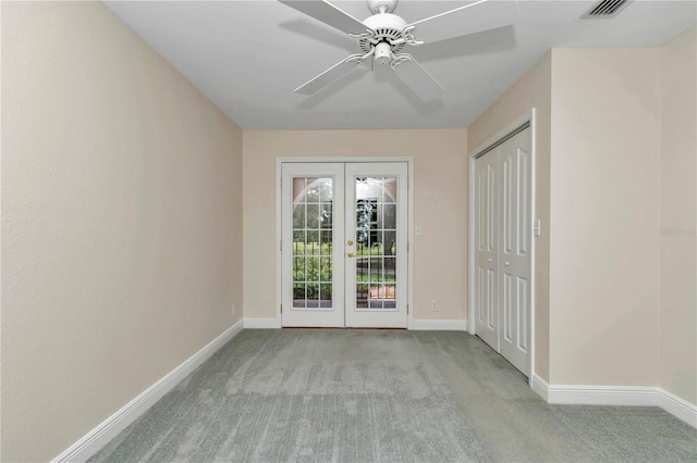 empty room with carpet floors, french doors, and ceiling fan