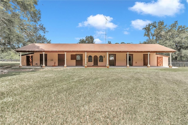 rear view of house featuring a lawn