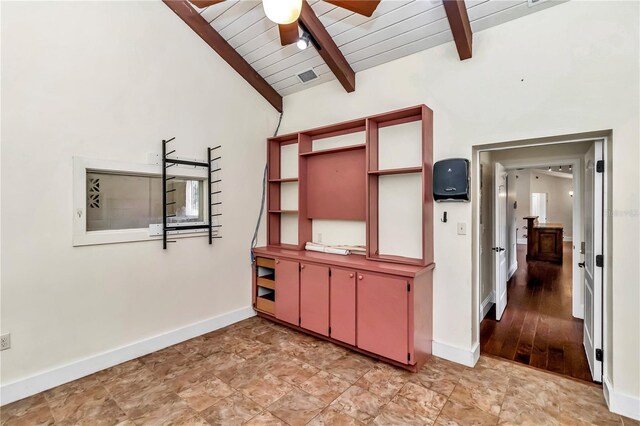 interior space with tile patterned floors, lofted ceiling with beams, and ceiling fan