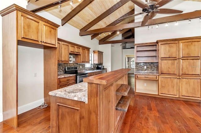 kitchen with beamed ceiling, electric range oven, tasteful backsplash, and rail lighting