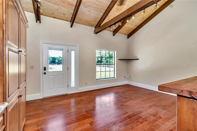 entrance foyer featuring rail lighting, beam ceiling, high vaulted ceiling, wooden ceiling, and dark hardwood / wood-style flooring