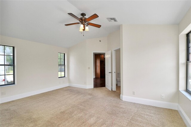 unfurnished room featuring lofted ceiling, light colored carpet, and ceiling fan