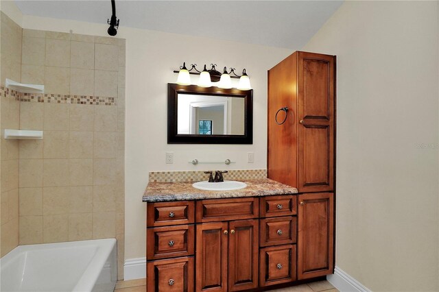 bathroom featuring vanity, tiled shower / bath combo, and tile patterned floors