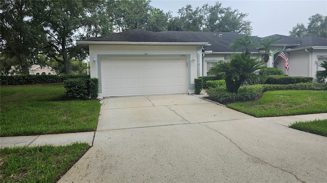 ranch-style home with a garage and a front lawn