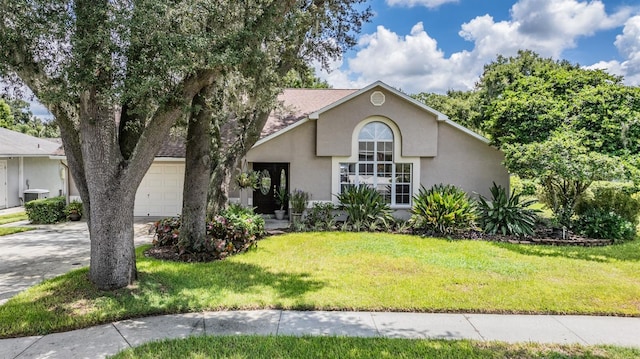 view of front of property with a garage, cooling unit, and a front lawn