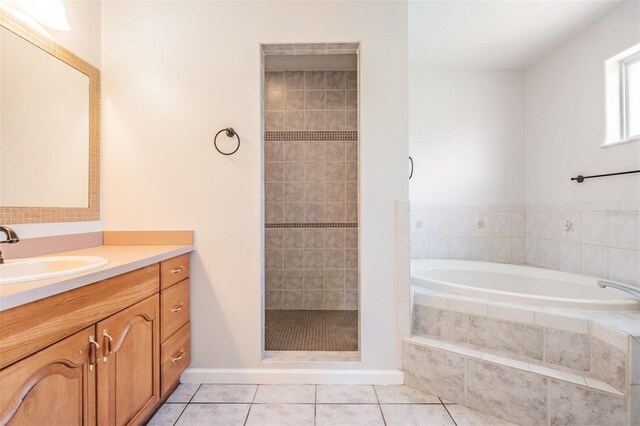 bathroom featuring tile patterned flooring, vanity, and separate shower and tub