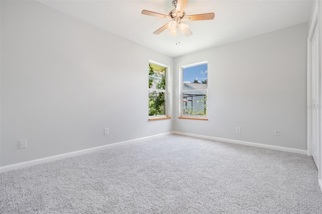 carpeted empty room with ceiling fan