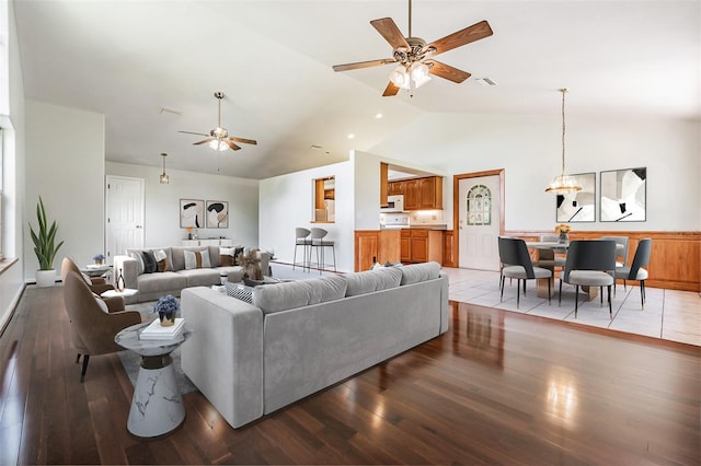 living room featuring hardwood / wood-style flooring, vaulted ceiling, and ceiling fan