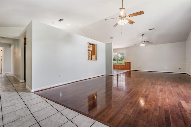 interior space with light hardwood / wood-style flooring, ceiling fan, and vaulted ceiling