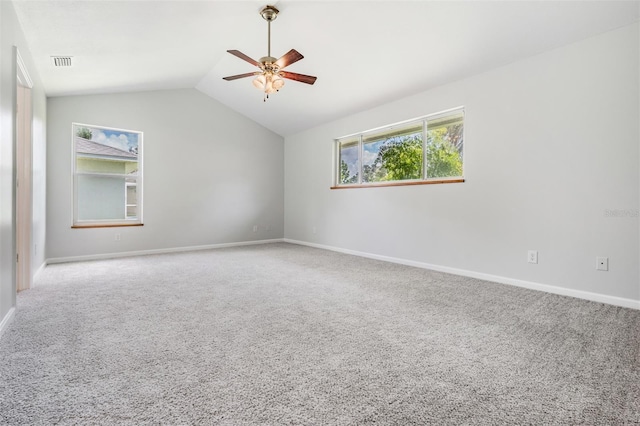 carpeted spare room with vaulted ceiling and ceiling fan