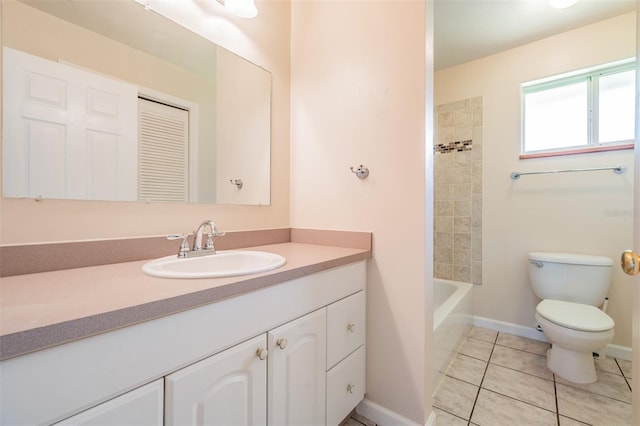 full bathroom with tile patterned flooring, vanity, tiled shower / bath, and toilet