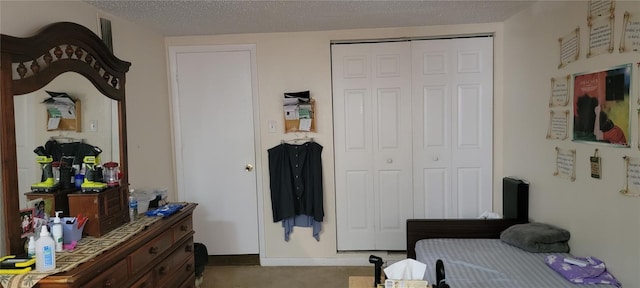 bedroom with light carpet, a textured ceiling, and a closet