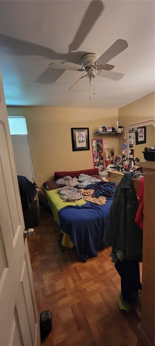 bedroom featuring parquet flooring and ceiling fan