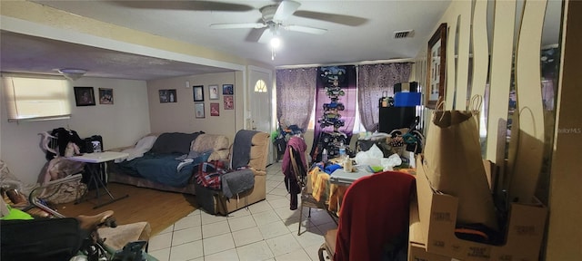 interior space featuring light tile patterned floors and ceiling fan