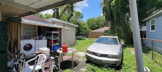 view of yard featuring washing machine and dryer