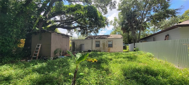 back of property featuring a storage shed