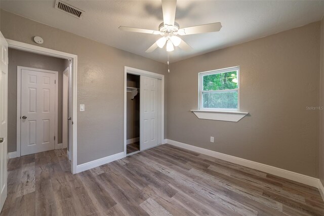 unfurnished bedroom with a closet, ceiling fan, and light hardwood / wood-style flooring