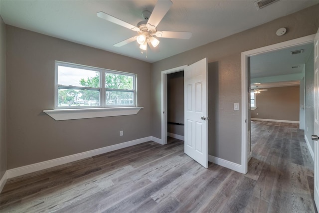 unfurnished bedroom featuring hardwood / wood-style flooring and ceiling fan