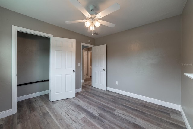 unfurnished bedroom with hardwood / wood-style floors and ceiling fan