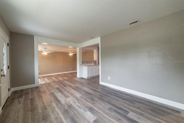 unfurnished living room featuring ceiling fan and light wood-type flooring