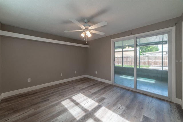 empty room with ceiling fan and hardwood / wood-style floors