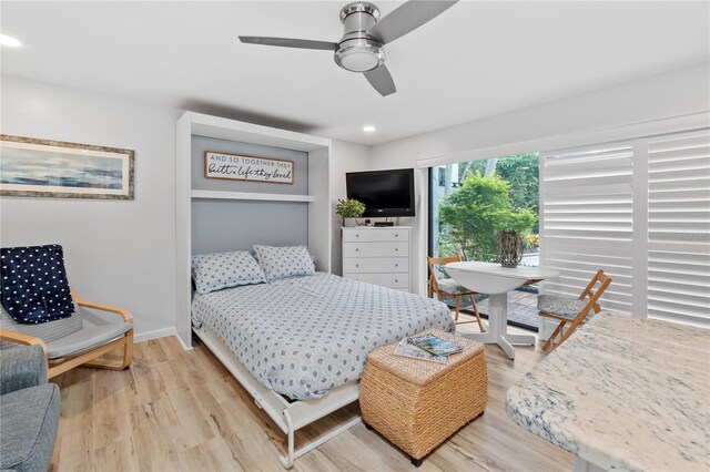 bedroom with light hardwood / wood-style flooring and ceiling fan