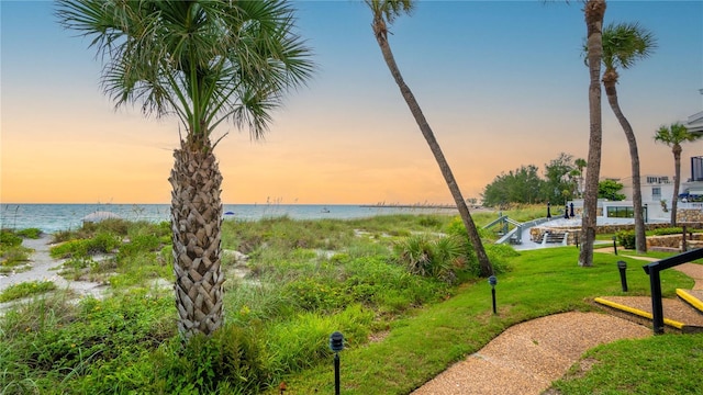 view of community with a water view and a yard