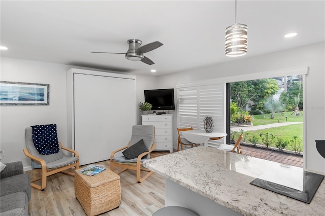 interior space featuring light wood-style flooring, a ceiling fan, and recessed lighting