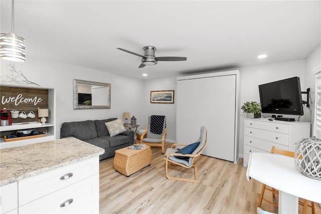 living room with light wood-style floors, ceiling fan, and recessed lighting