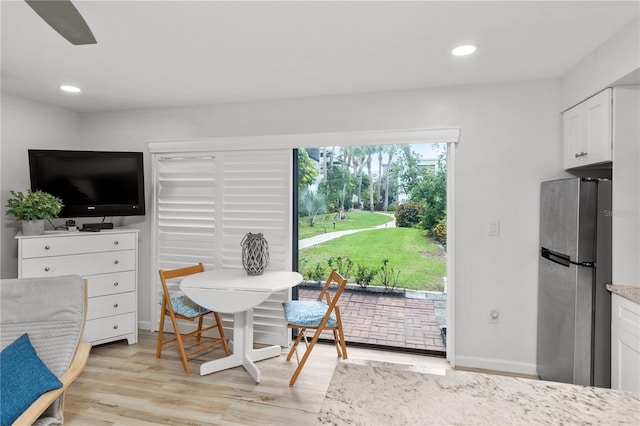 dining space with light hardwood / wood-style floors