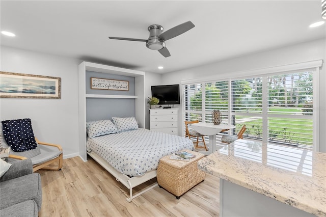 bedroom with ceiling fan and light hardwood / wood-style flooring